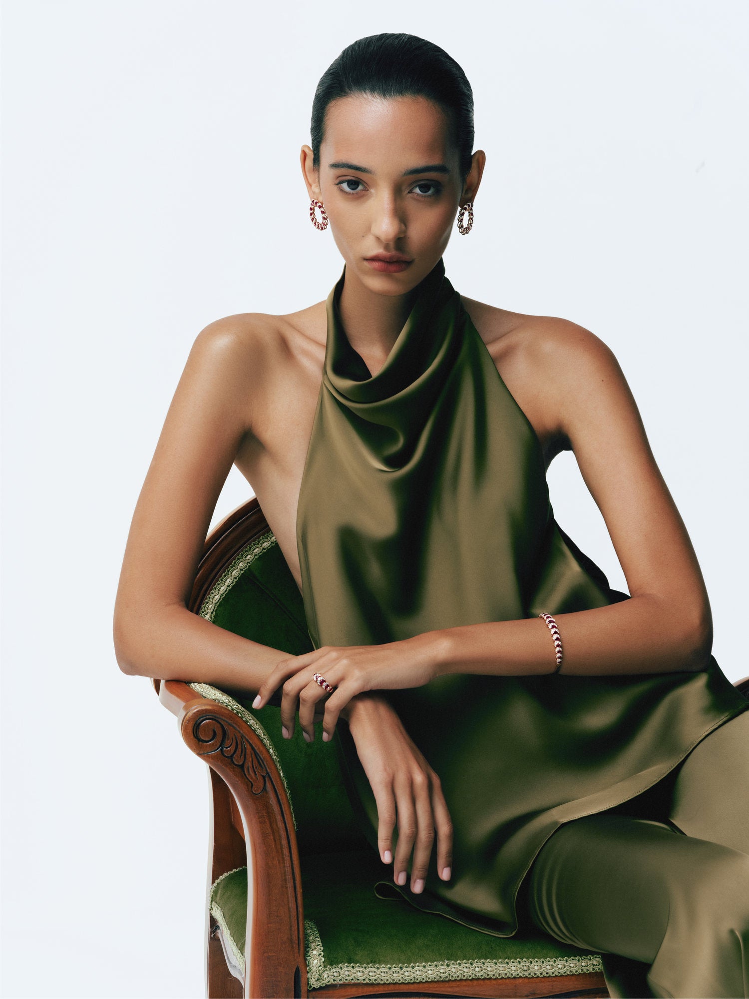 Model in green satin wearing the Ruby Crescent Hoop Earrings, Ring and Bangle