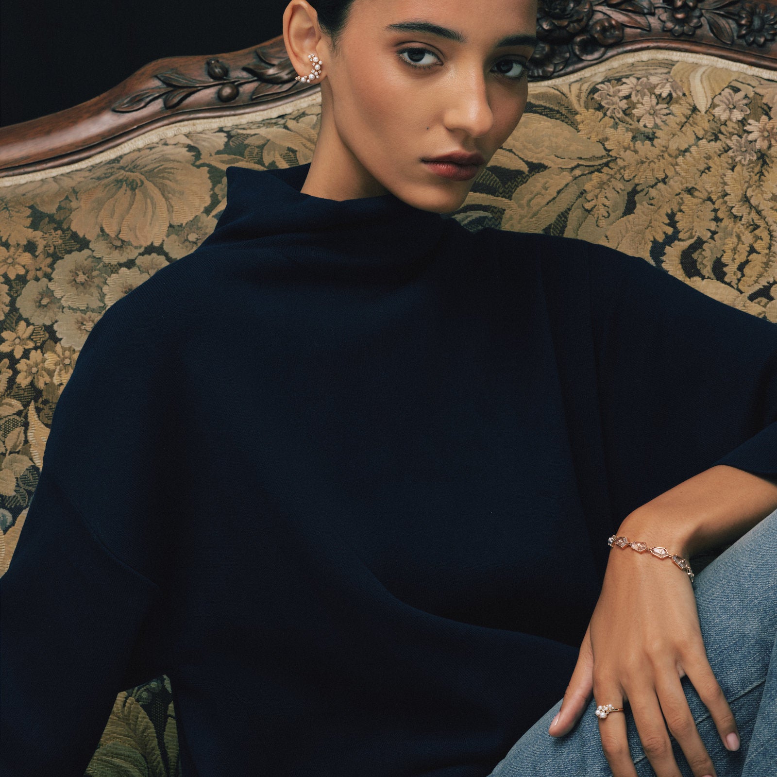 Model wearing the Crystal Prisme Link Bracelet and Pearl Wing Ring