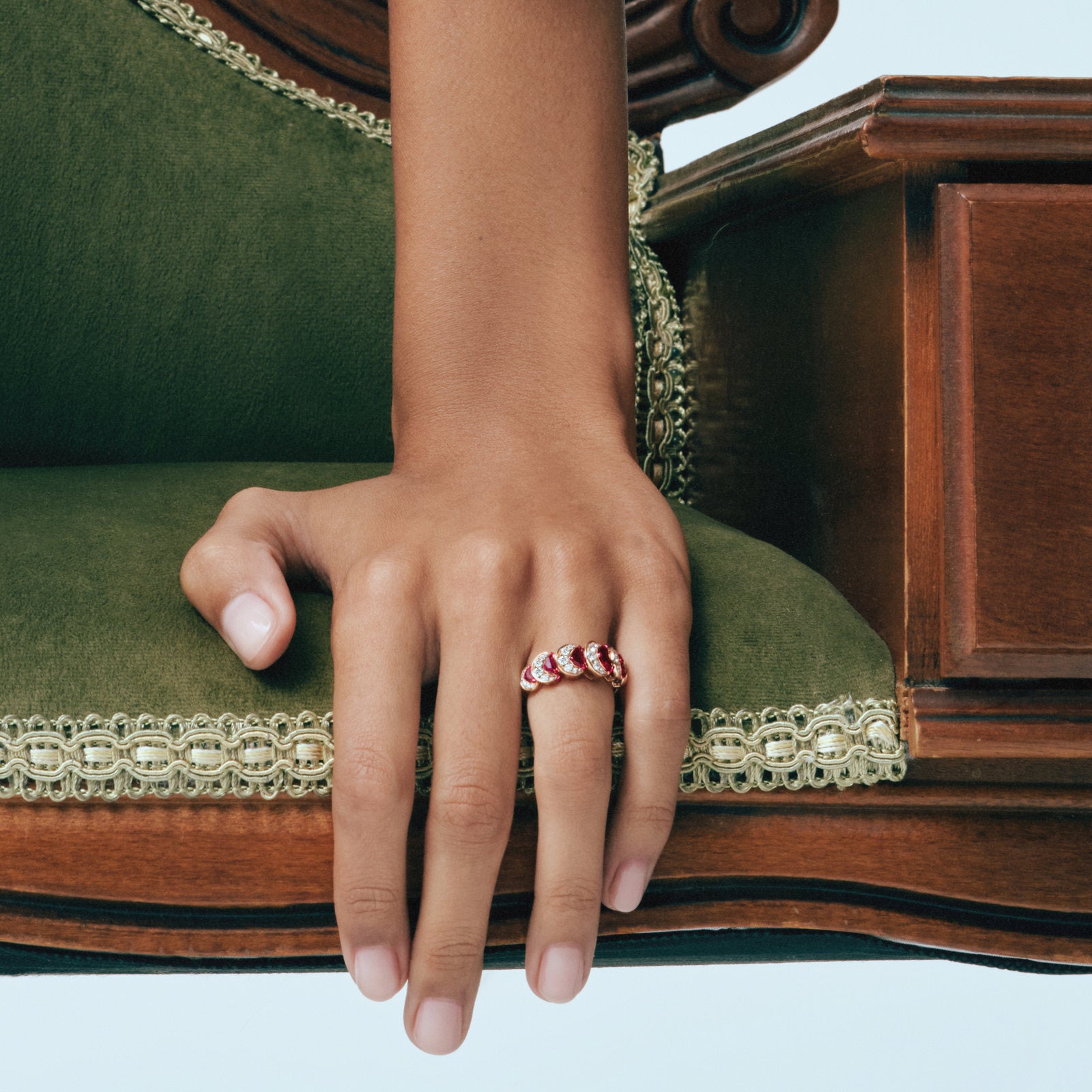 Hand wearing the Ruby Crescent Ring and Ruby Crescent Bangle