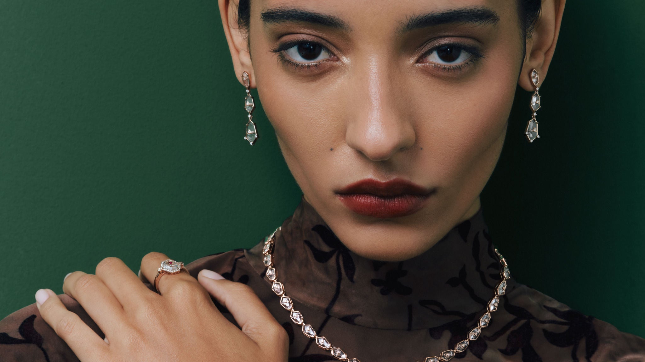Model wearing the Crystal Prisme Charm Choker, Drop Earrings and Statement Ring