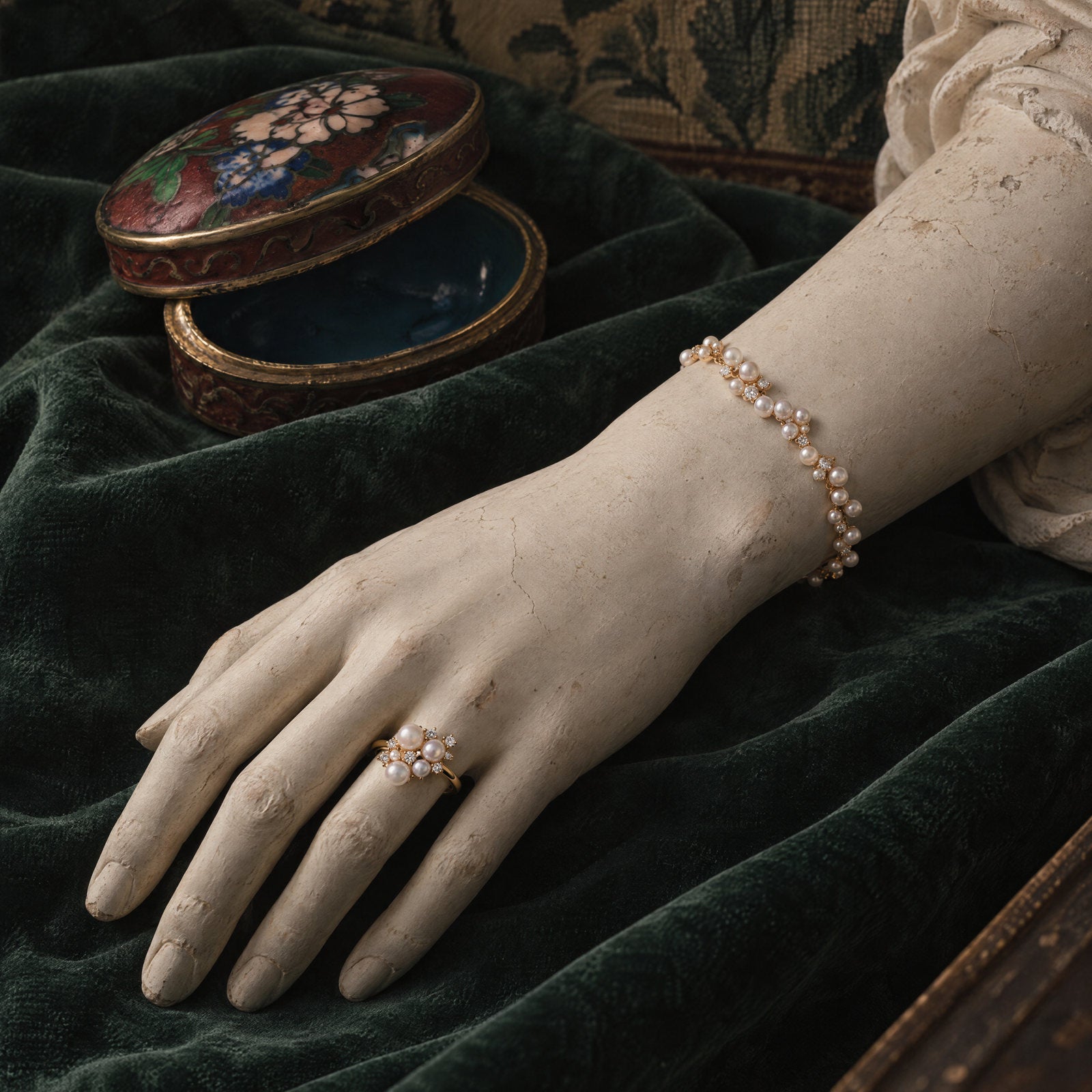 Plaster hand wearing the Pearl Wing Ring and Pearl Bracelet