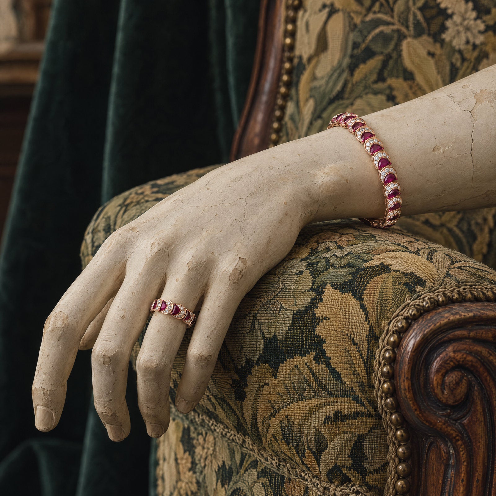 Plaster hand wearing the Ruby Crescent Ring and Ruby Crescent Bangle