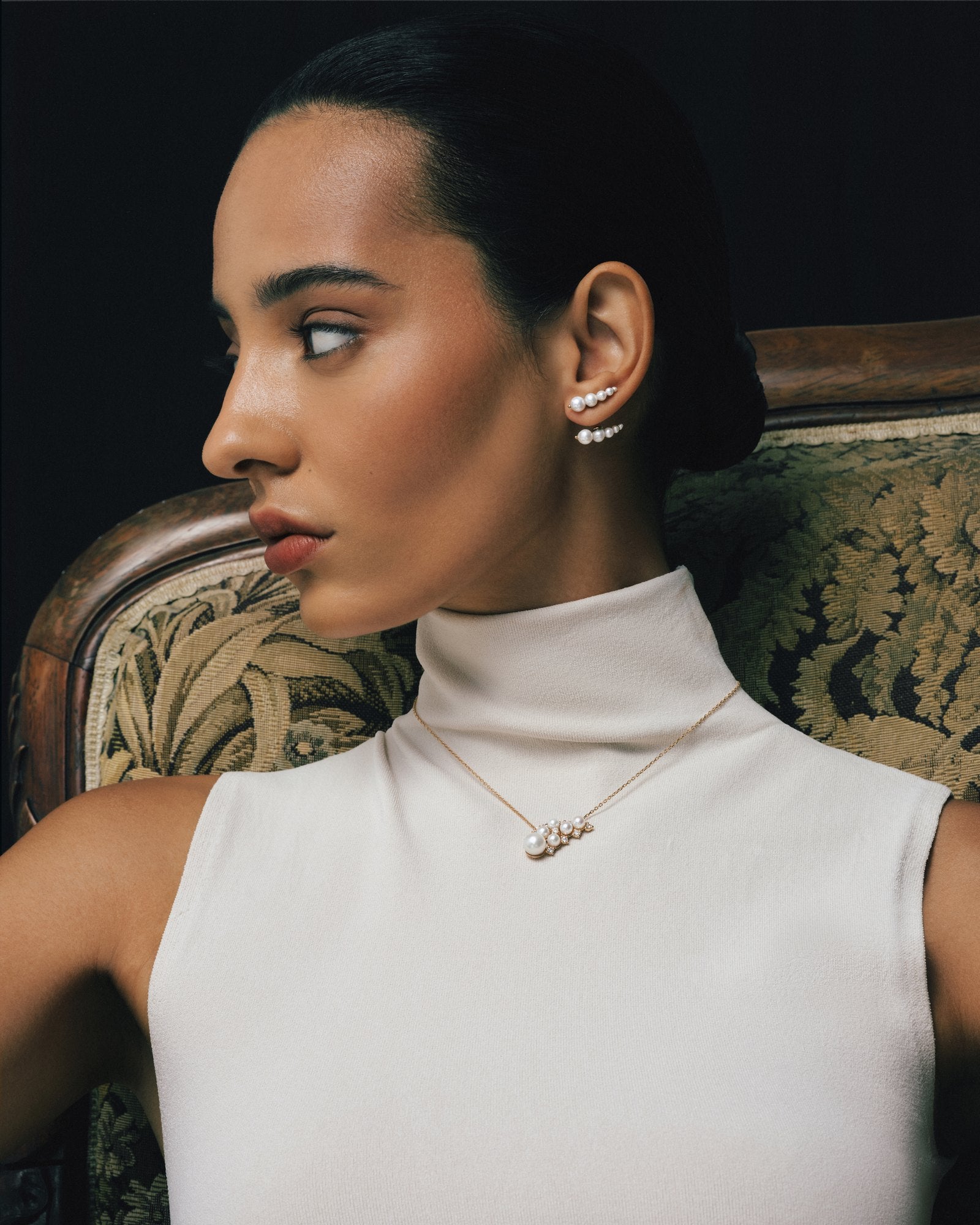Model wearing the Pearl Wing Pendant and Pearl Wing Earrings in 18K rose gold